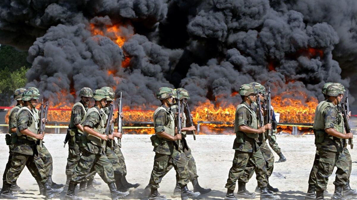 Mexican soldiers march past the incineration of 23.5 tons of cocaine in Manzanillo, in Colima state.