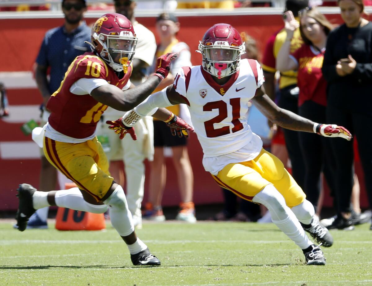 USC receiver Kyron Ware-Hudson and cornerback Latrell McCutchin look for the ball up field during the spring game