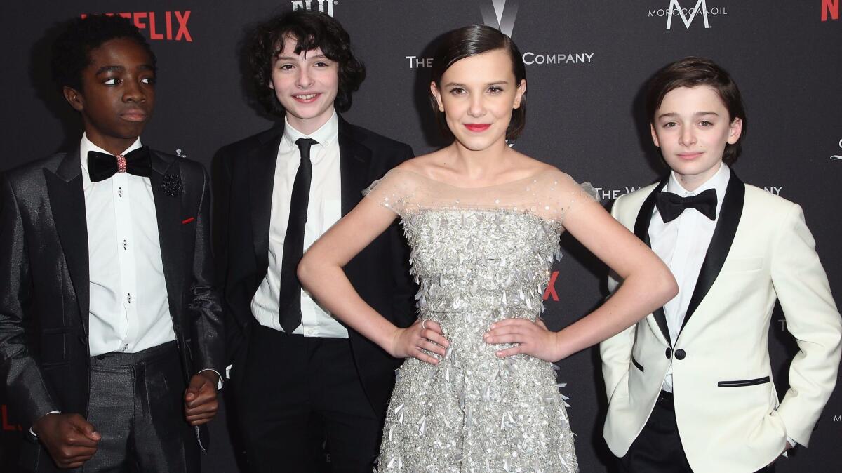 From left, "Stranger Things" cast members Caleb McLaughlin, Finn Wolfhard, Millie Bobby Brown and Noah Schnapp were among the guest who turned out to the Weinstein Co./Netflix party.