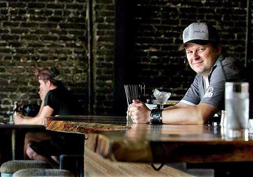 Ryan Ballinger, co-owner with Gabriel Byer of the York in Highland Park, has a seat at the bar, an L-shaped hunk of polished South American hardwood. The gastropub lists its food and drink menu on blackboards on the exposed-brick side walls.