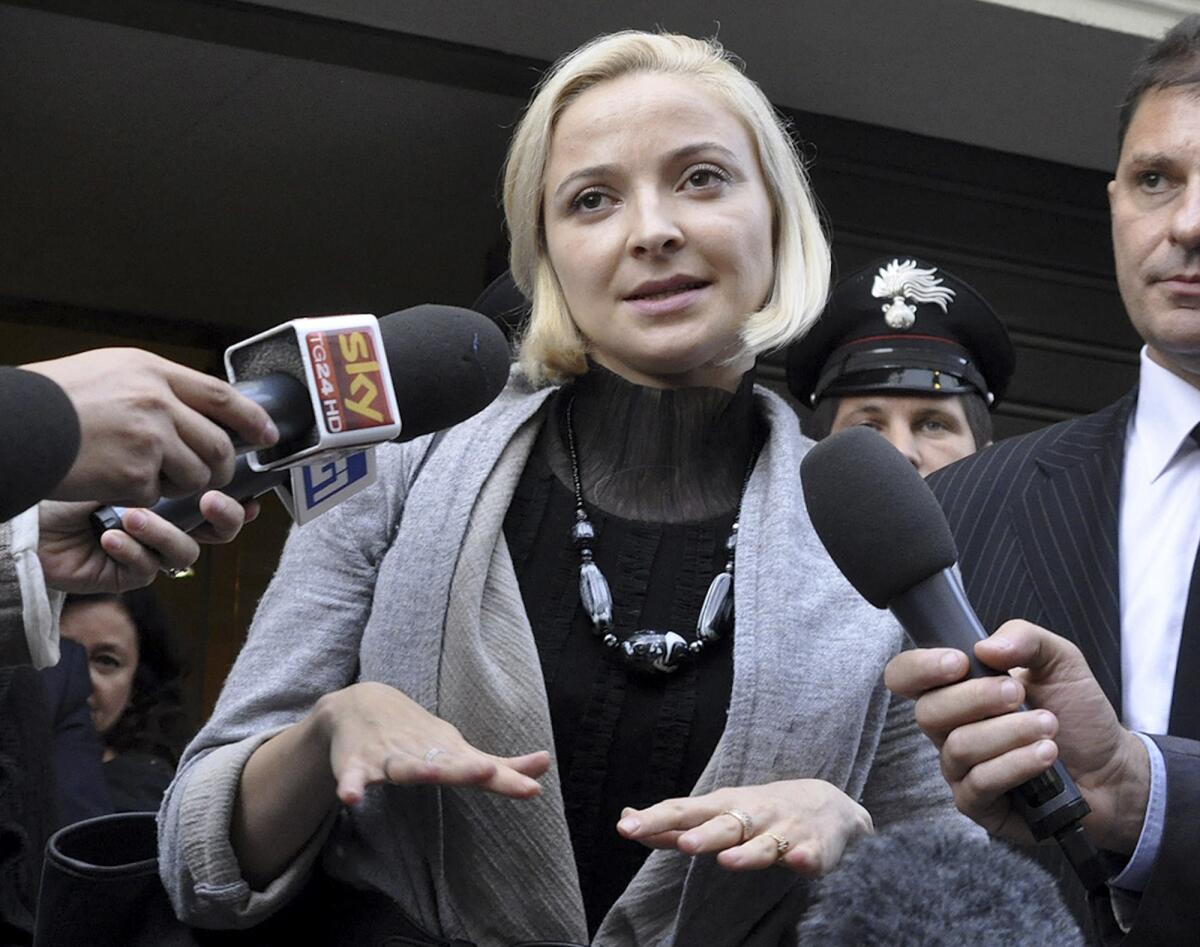 Domnica Cemortan leaves the converted Teatro Moderno theater after testifying Tuesday in a hearing in the trial of Captain Francesco Schettino, in Grosseto, Italy. The Moldovan dancer, who was on the bridge when the cruise ship Costa Concordia crashed into a reef, testified that she was the captain's lover.