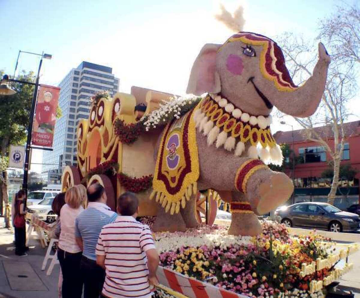 Passersby check out the 2012 Glendale Rose Parade float parked on the 200 block of North Brand Blvd. in Glendale.