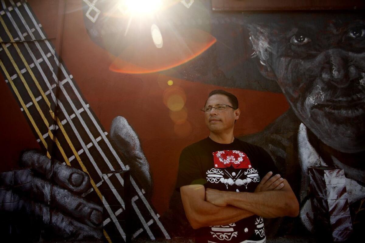 Carlos Gaspar, shown in front of a mariachi mural near Mariachi Plaza, has been denied a permit for a mariachi-themed 5-kilometer fun run in Boyle Heights.