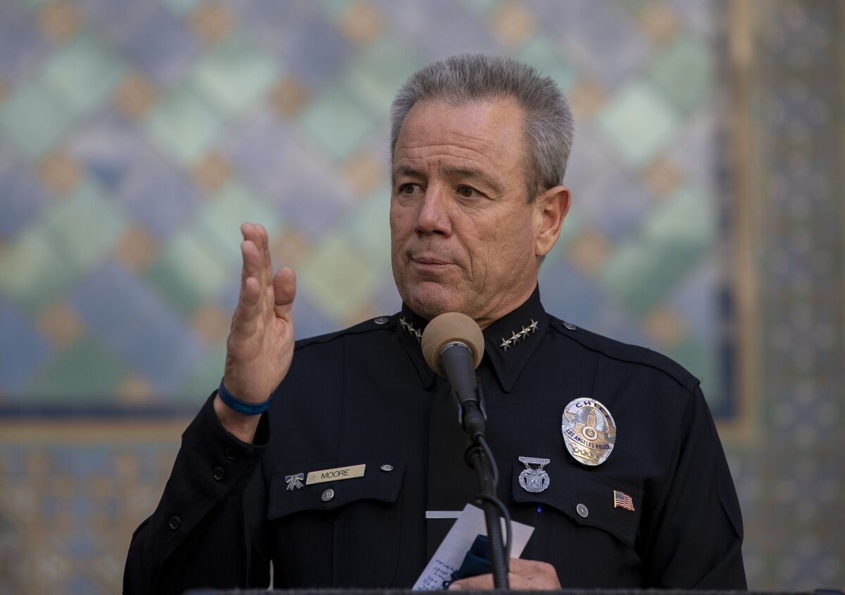 Los Angeles Police Chief Michel Moore speaks into a microphone