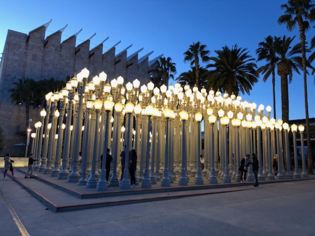 The Los Angeles County Museum of Art's "Urban Light" installation provided some levity and a creative outlet amid the coronavirus outbreak Tuesday evening.