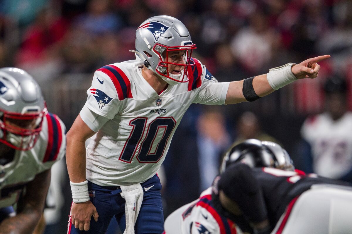 New England Patriots quarterback Mac Jones works against the Atlanta Falcons.