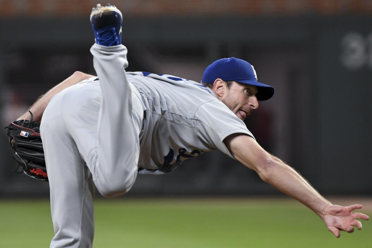 Dodgers starting pitcher Max Scherzer delivers during the first inning.