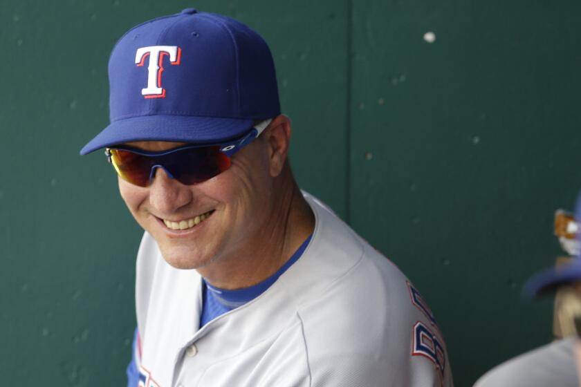 Texas Rangers Manager Jeff Banister smiles in the dugout during the eighth inning of a win over the Kansas City Royals on June 6.