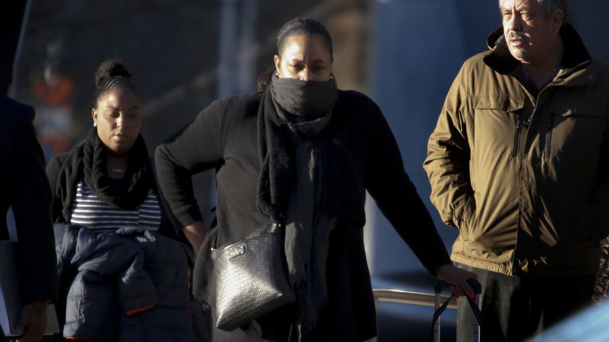 Pedestrians bundle up against the cold Monday in downtown Los Angeles.