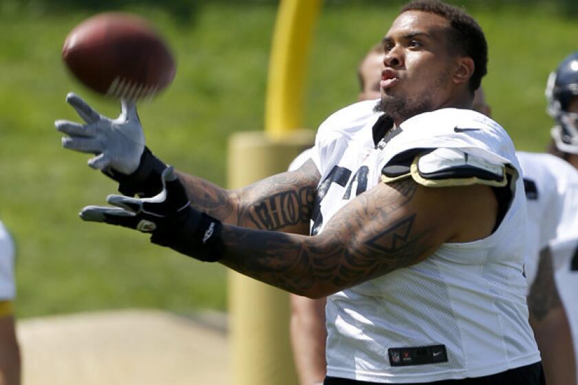 Steelers center Maurkice Pouncey misses the ball as he takes part in a punt-catching drill during training camp this summer.