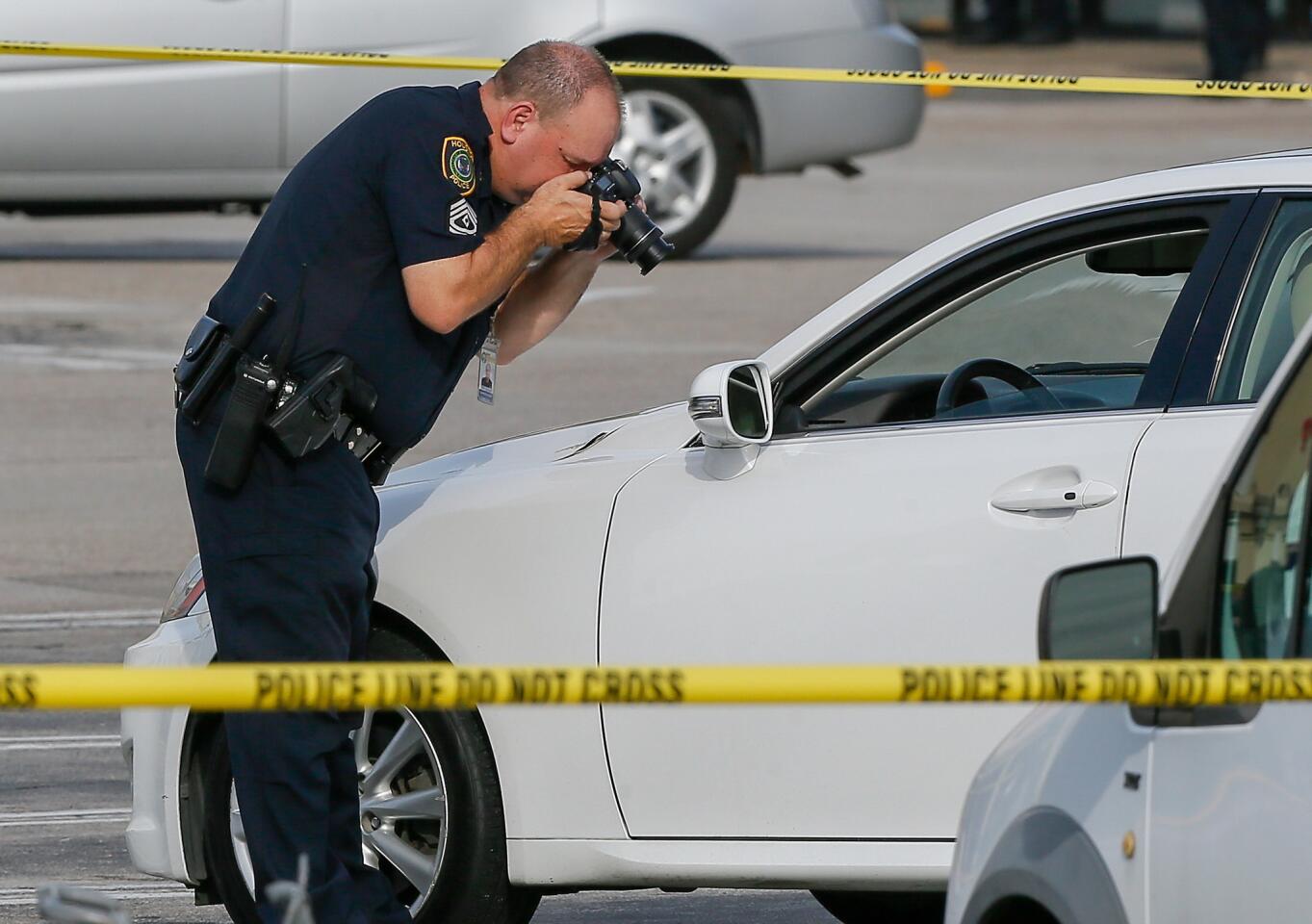 A police investigator photographs a vehicle with gunshot damage Sept. 26, 2016, in Houston.