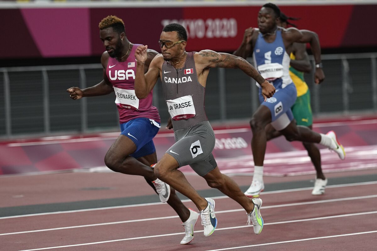 Andre De Grasse of Canada runs ahead of the U.S.' Kenneth Bednarek at the Tokyo Olympics.
