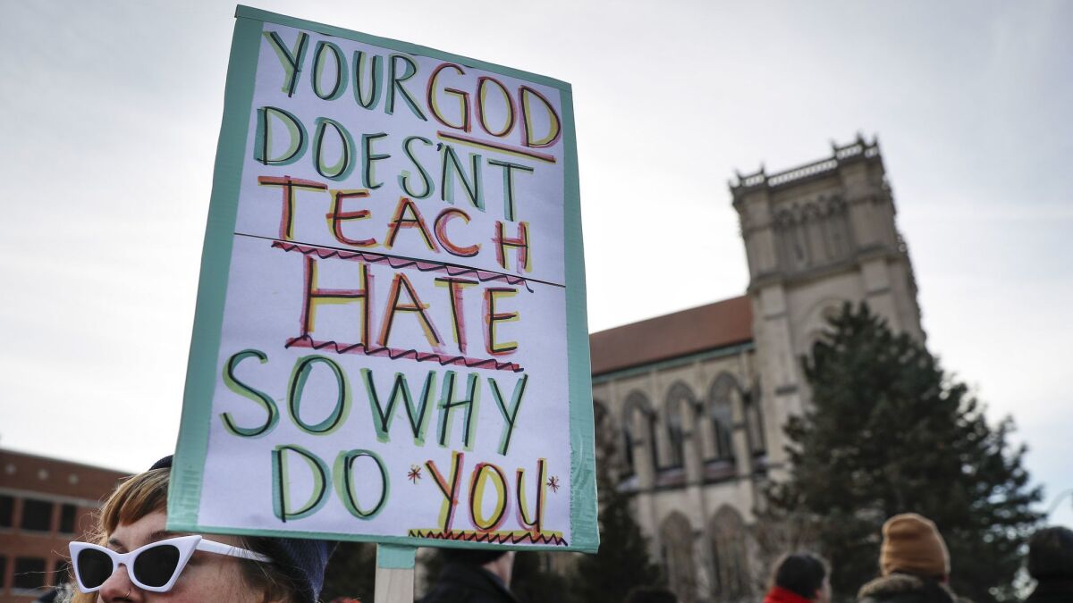 Protesters gather outside the Catholic Diocese of Covington on Tuesday.