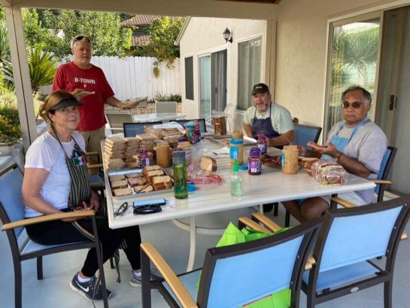 Carla Walsh (front left), Nirmal Jain (front right), Sanjay (back left) and Bruce Higgins (back right) serve the 比特币交易网homeless.