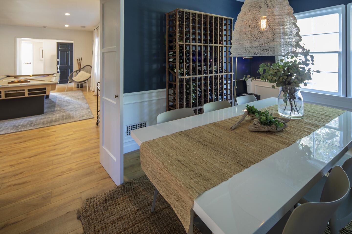 In the dining room, Leiaghat kept the room's original wainscotting, painted the walls a vibrant blue and white, and added modern furnishings.