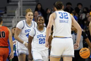 UCLA guard Charisma Osborne (20), reacts with forward Angela Dugalic (32).