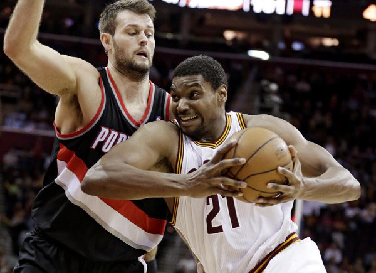 Andrew Bynum drives against Trail Blazers center Joel Freeland while playing for Cleveland this season.