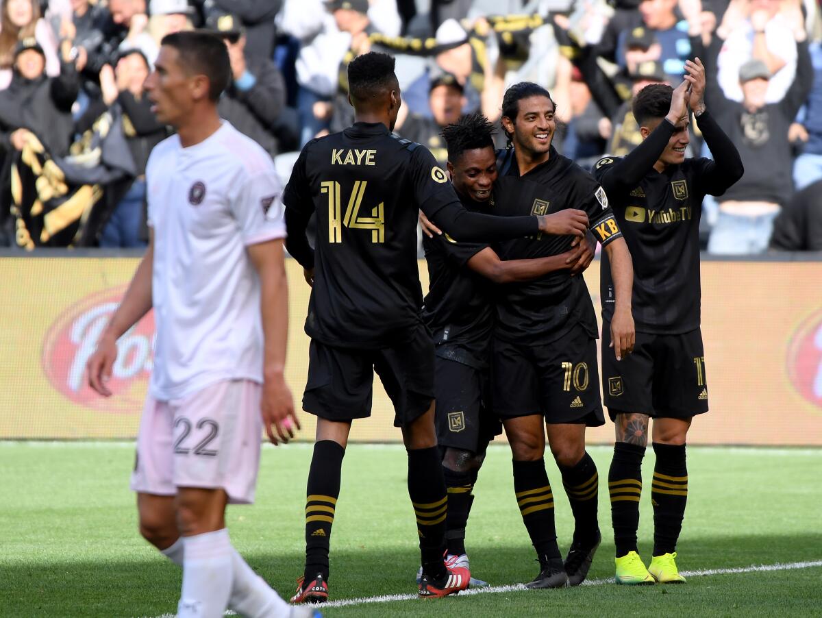 LAFC forward Carlos Vela (10) gathers with his teammates after scoring during the team's 1-0 season-opening victory over Inter Miami at Banc of California Stadium on Sunday.