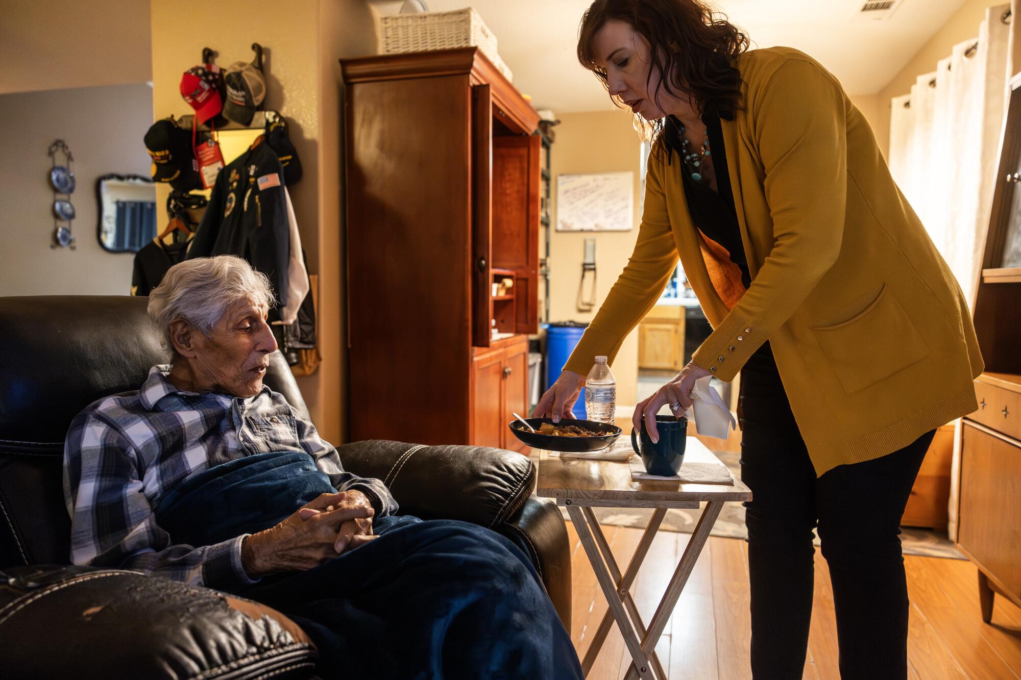 Kimberly Guthrie serves Bob Fernandez dinner after coming home from work.