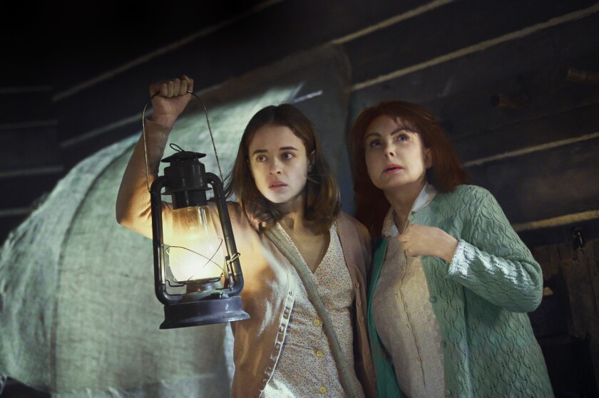Raechelle Bano holds a lit lantern, with Naomi Judd, in "V.C. Andrews' Ruby." 