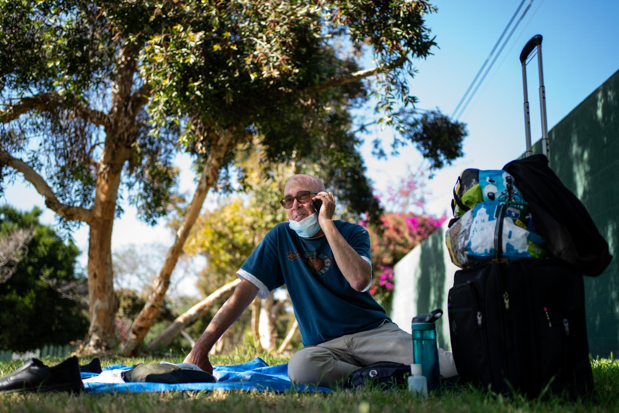 Terrance Whitten sits on a blanket outdoors.