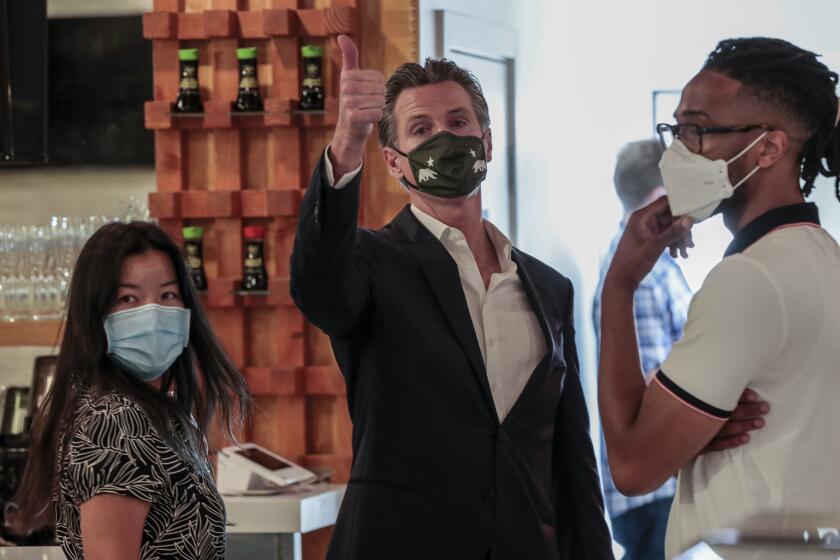 San Fernando, CA, Thursday, April 29, 2021 - California Governor Gavin Newsom waves goodbye to friends after attending a press conference where he signed legislation that will provide a $6.2 billion tax cut to the hardest hit small businesses in the state at Hanzo Sushi restaurant downtown. (Robert Gauthier/Los Angeles Times)