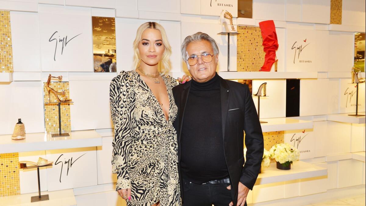 Singer Rita Ora, left, and footwear designer Giuseppe Zanotti at the launch event for their Giuseppe for Rita Ora shoe collection at Saks Fifth Avenue in Beverly Hills.