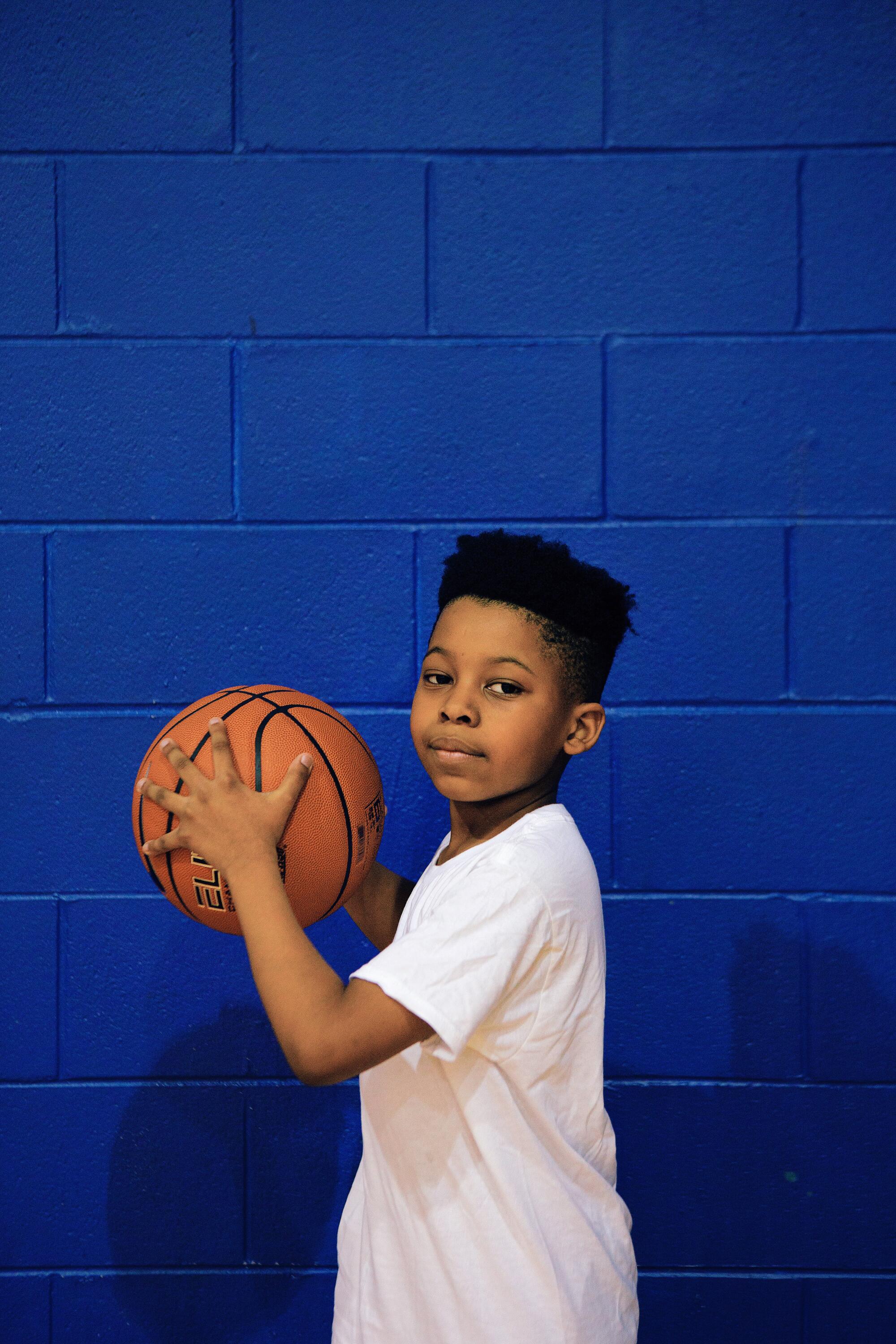 Jaeden Ackles, a 9-year-old fan of LeBron James, poses for a photo at Summit Lake Community Center.