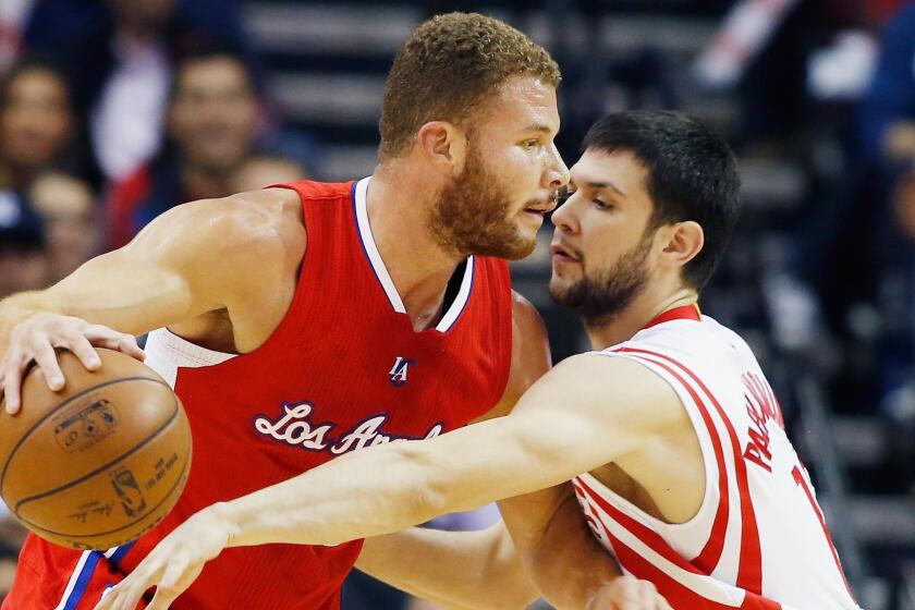 Clippers power forward Blake Griffin, left, tries to drive past Houston Rockets small forward Kostas Papanikolaou during the Clippers' win on Friday.