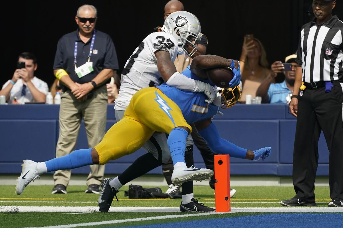 Chargers tight end Gerald Everett scores a touchdown against Las Vegas Raiders safety Roderic Teamer.
