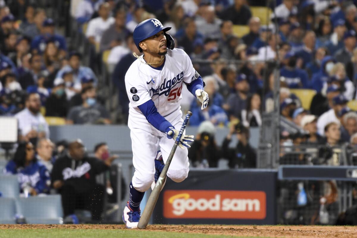 Mookie Betts tosses his bat after hitting a two-run home run for the Dodgers in the fourth inning.