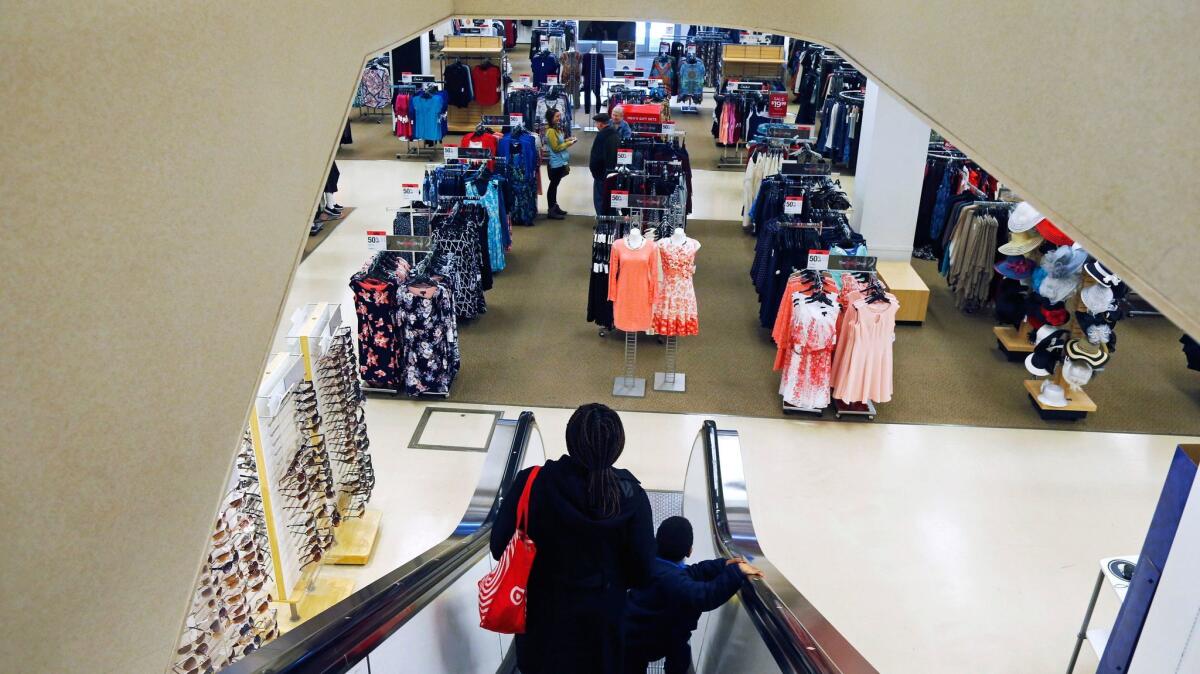 A woman and child ride the escalator at a Sears store in St. Paul, Minn.