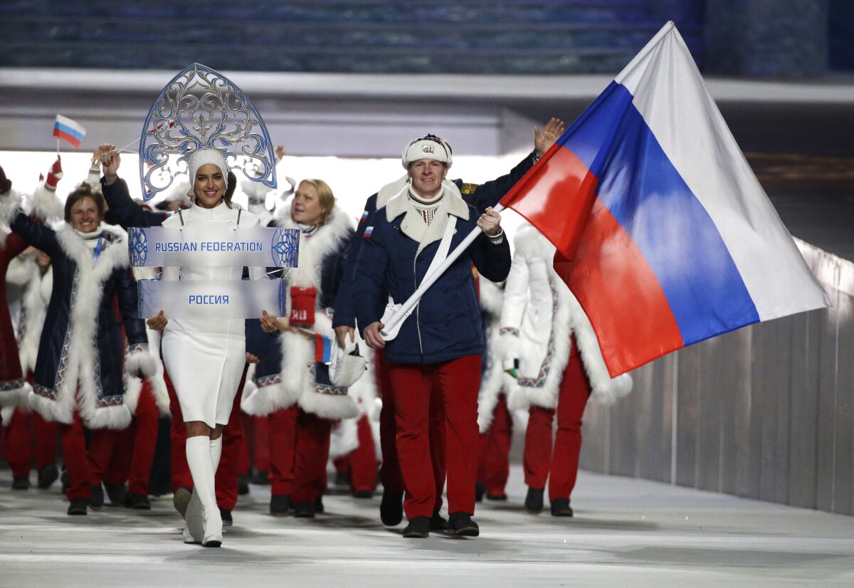 Alexander Zubkov of Russia carries the national flag as he leads the team during the opening ceremony of the 2014 Winter Olympics in Sochi, Russia.
