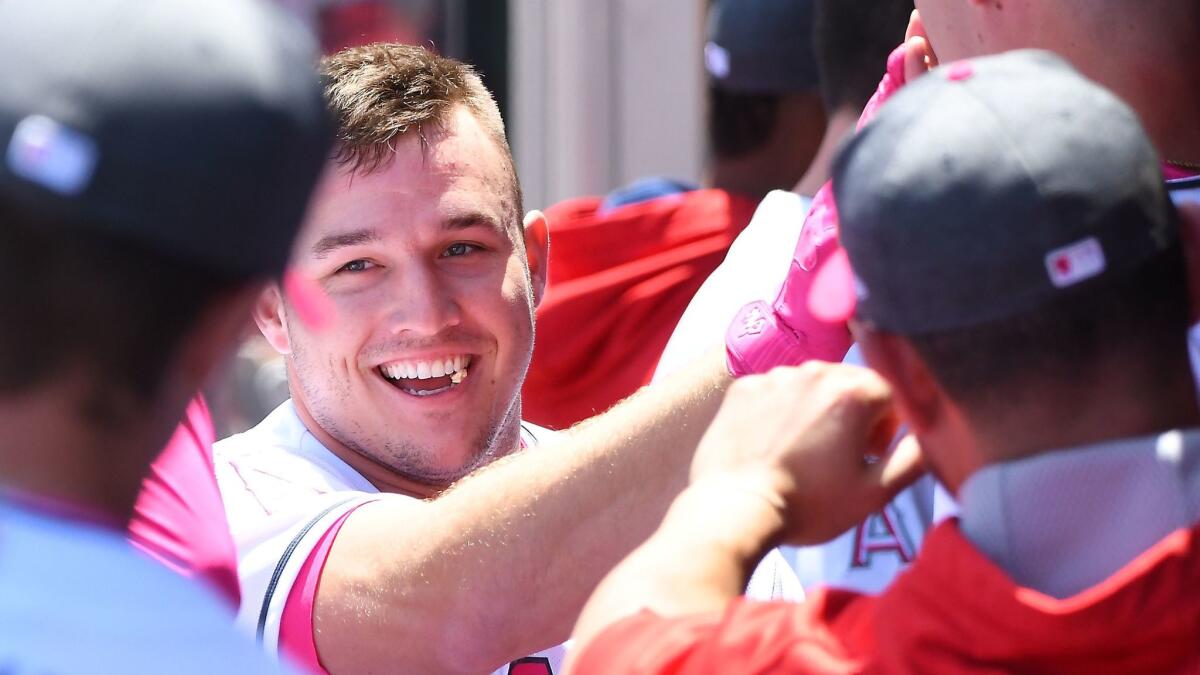Angels' Mike Trout is greeted in the dugout after a home run against Detroit on May 14.