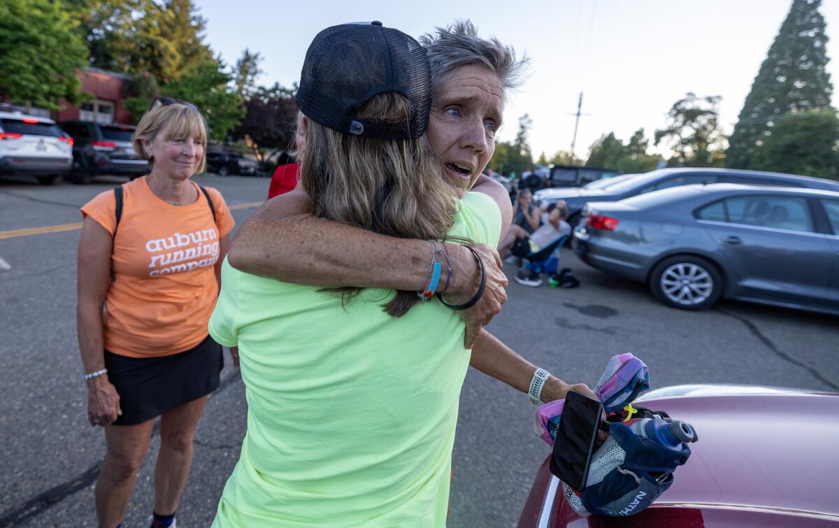 Luanne Park hugs Renee Thomas, her wife and partner of 37 years, after dropping out of the Western States 100