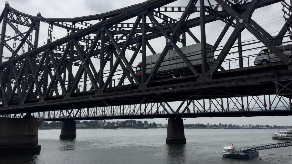 Trucks cross the SinoâKorean Friendship Bridge from North Korea into Dandong, China.