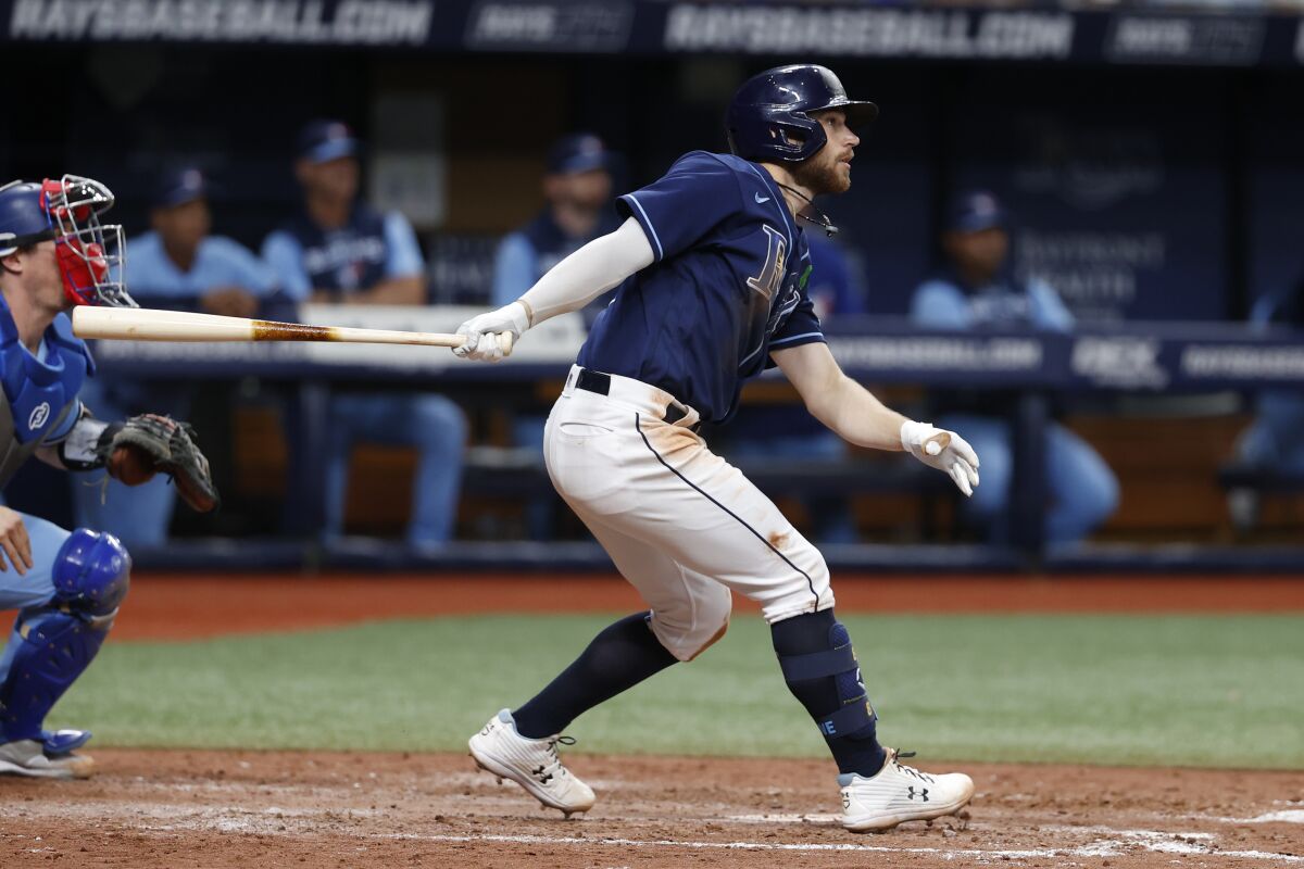 Tampa Bay Rays' Brandon Lowe hits an RBI-triple during the eighth inning of a baseball game against the Toronto Blue Jays, Friday, May 13, 2022, in St. Petersburg, Fla. (AP Photo/Scott Audette)