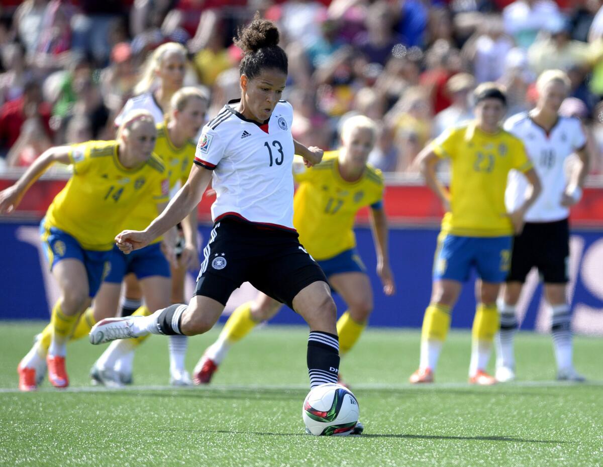 Celia Sasic of Germany kicks the ball on a penalty kick to score against Sweden during the first half of a Round of 16 match Saturday at the Women's World Cup.