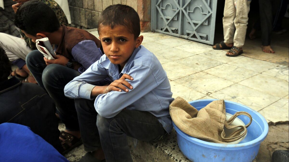 A Yemeni boy waits to receive a meal at an orphanage in Sana'a, Yemen.