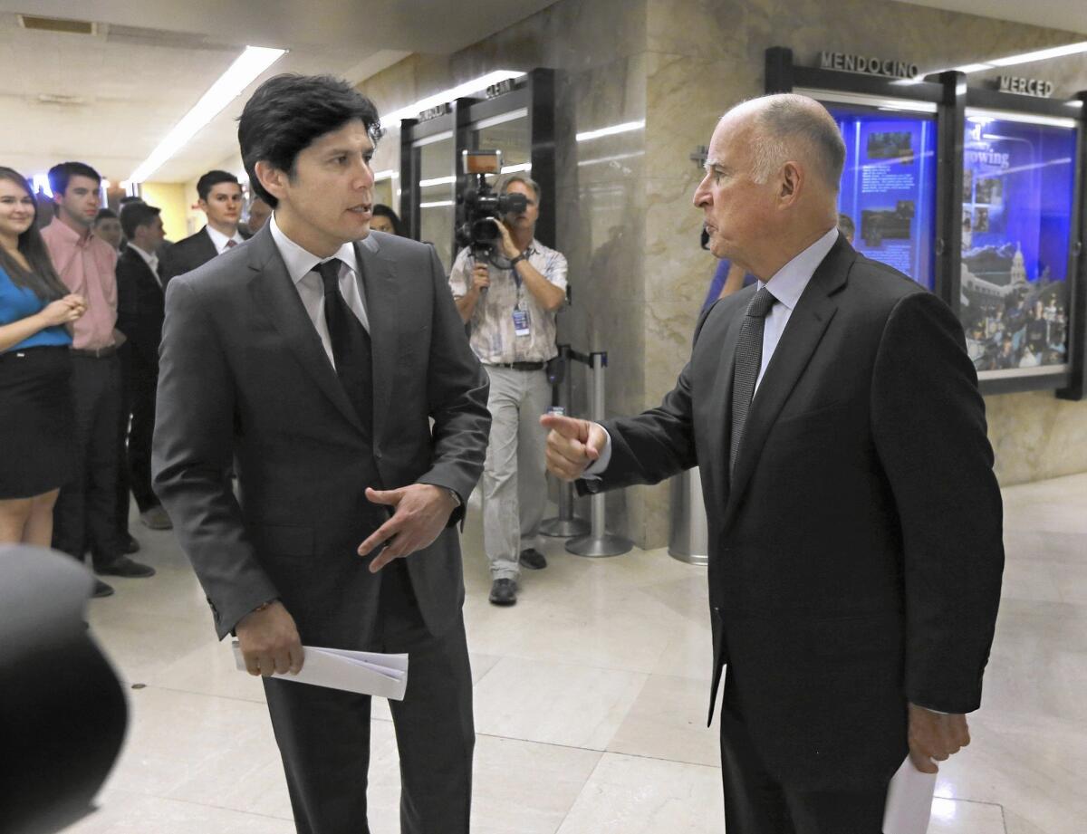 State Senate leader Kevin de León (D-Los Angeles), left, and Gov. Jerry Brown are working together to secure support from utilities for climate-change legislation that would increase the state’s use of renewable energy.