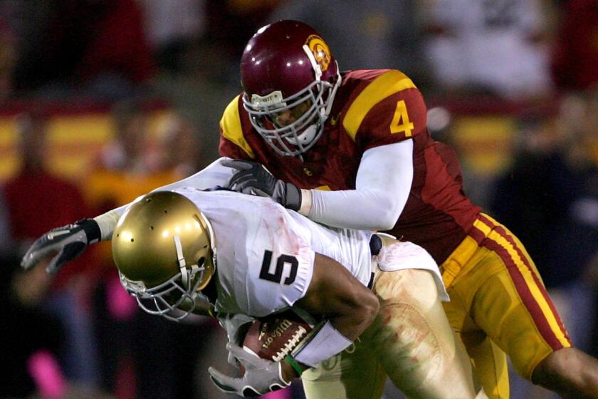 LOS ANGELES - NOVEMBER 25: Safety Kevin Ellison #4 of the USC Trojans tackles receiver Rhema McKnight #5 of the Notre Dame Fighting Irish on November 25, 2006 at the Los Angeles Memorial Coliseum in Los Angeles, California. USC won 44-24. (Photo by Stephen Dunn/Getty Images)