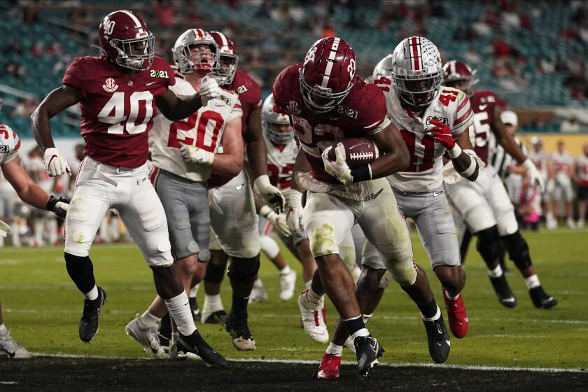 Alabama running back Najee Harris scores a touchdown against Ohio State during the second half of an NCAA College Football Playoff national championship game, Monday, Jan. 11, 2021, in Miami Gardens, Fla. (AP Photo/Lynne Sladky)