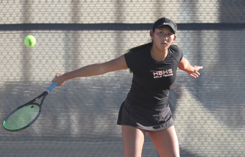 Huntington Beach's Solaya Han slices a shot against Corona del Mar on Tuesday.