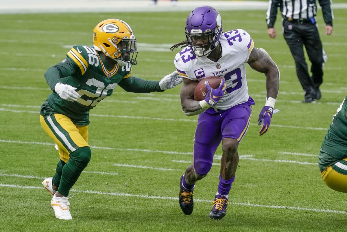 Minnesota Vikings' Dalvin Cook runs past Green Bay Packers' Darnell Savage during the first half of an NFL football game Sunday, Nov. 1, 2020, in Green Bay, Wis. (AP Photo/Morry Gash)