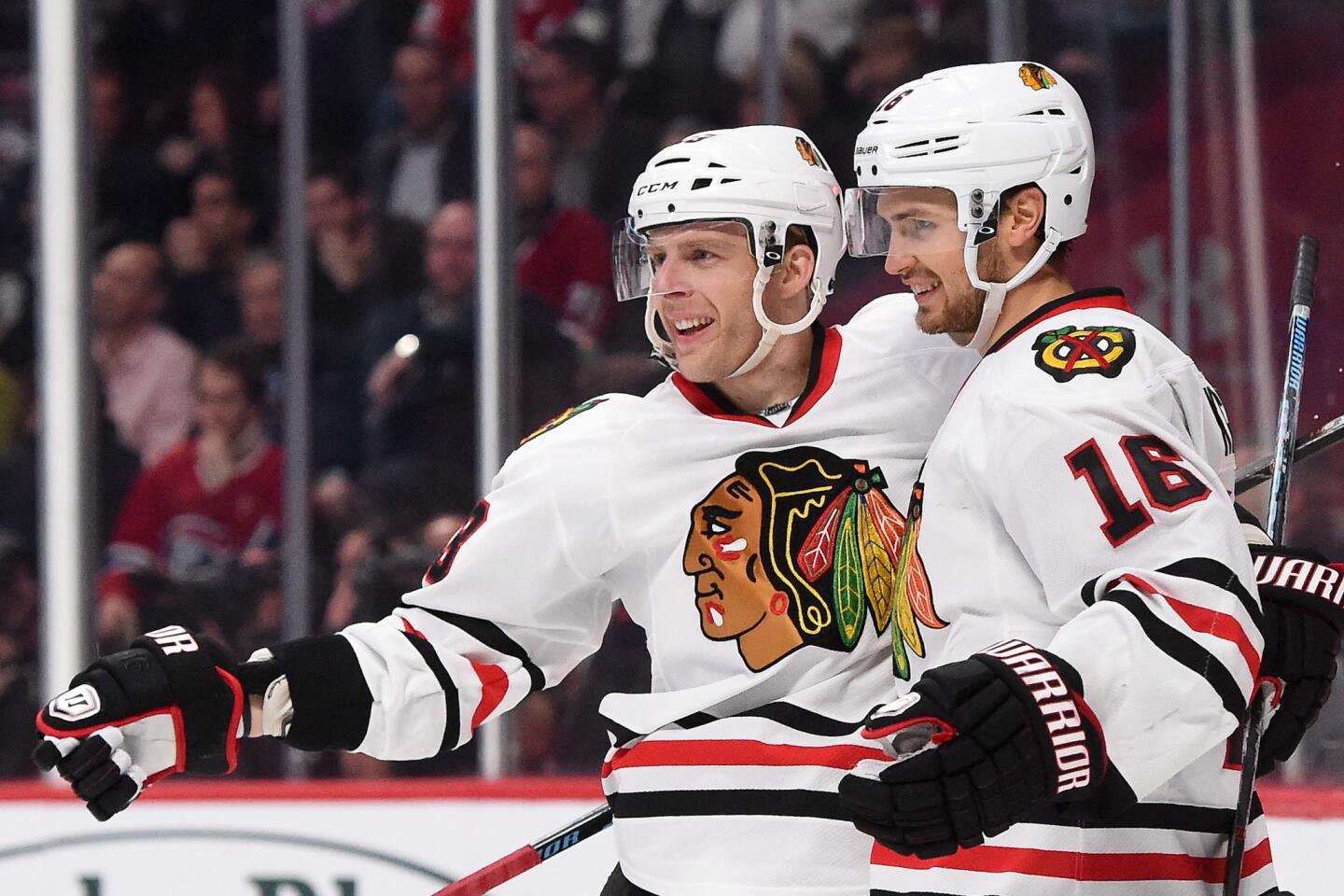 Marcus Kruger celebrates with Kris Versteeg after scoring a goal against the Montreal Canadiens.