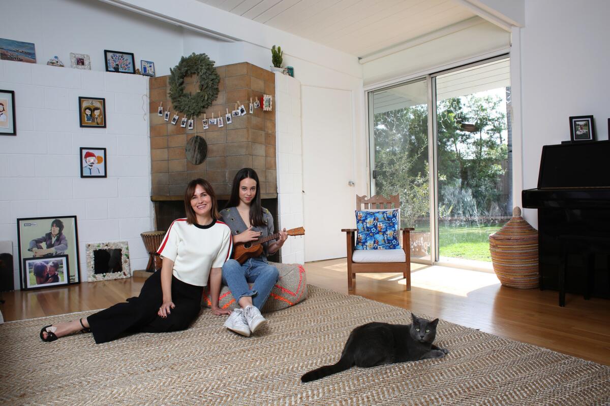 "Under the Eiffel Tower" star Judith Godrèche', left, with daughter Tess Barthelemy in their living room.