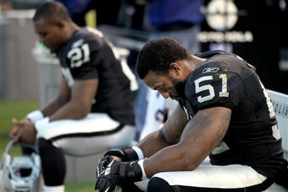 Oakland Raiders linebacker Aaron Curry (51) and defensive back Lito Sheppard (21) sit on the bench during the fourth quarter of an NFL football game against the San Diego Chargers in Oakland, Calif., Sunday, Jan. 1, 2012. The Chargers won 38-26. (AP Photo/Marcio Jose Sanchez)