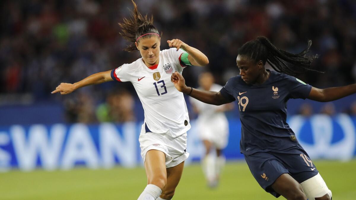 U.S. forward Alex Morgan, left, controls the ball next to France's Griedge Mbock Bathy during the United States' 2-1 victory in the Women's World Cup quarterfinals Friday.