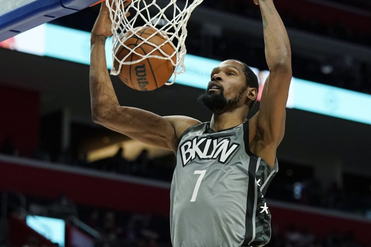 Brooklyn Nets forward Kevin Durant dunks during the second half of an NBA basketball game against the Detroit Pistons, Sunday, Dec. 12, 2021, in Detroit. (AP Photo/Carlos Osorio)