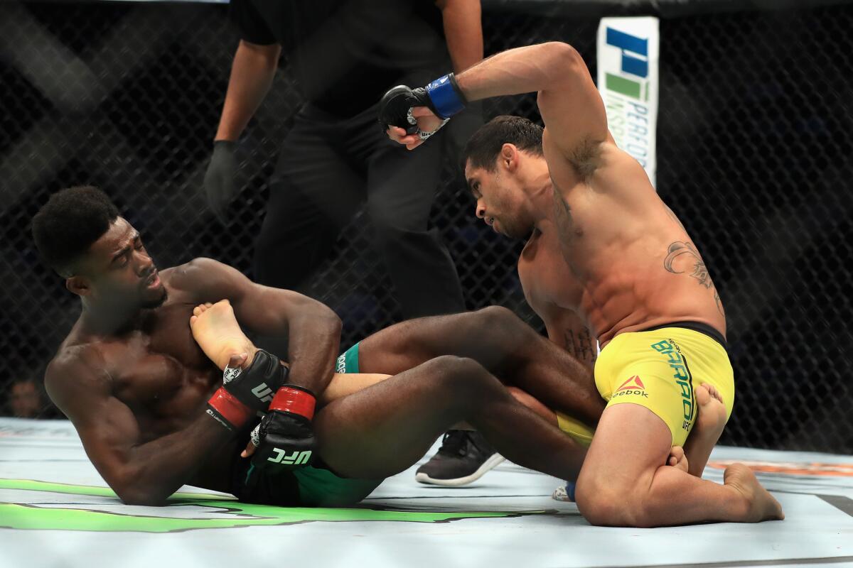 Aljamain Sterling attempts to submit Renan Barao during their bantamweight bout at UFC 214.